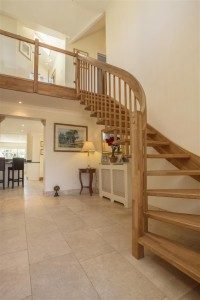 oak floating stair in a hallway with tiled floor