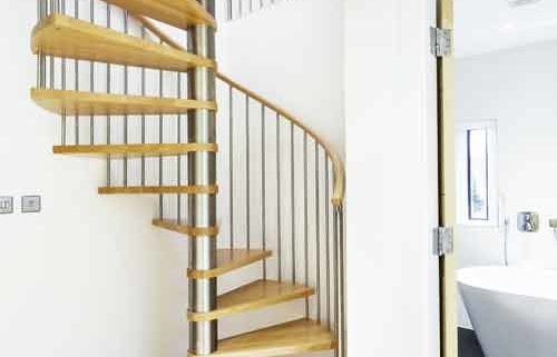 light wood floor and open riser spiral staircase with oak steps