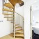 light wood floor and open riser spiral staircase with oak steps