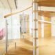 bottom section of an open riser oak spiral stair with stainless column