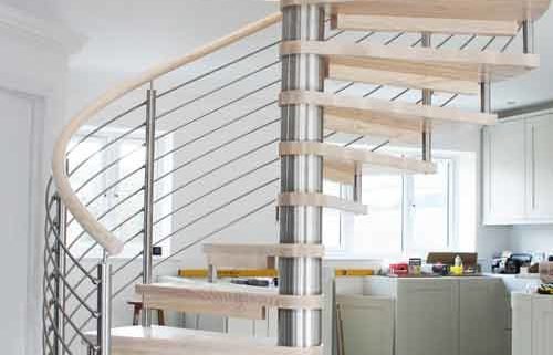 light wood spiral staircase with stainless steel balustrade