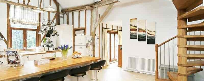 kitchen with breakfast bar with oak spiral staircase