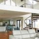 large mezzanine above a living space with modern spiral stair