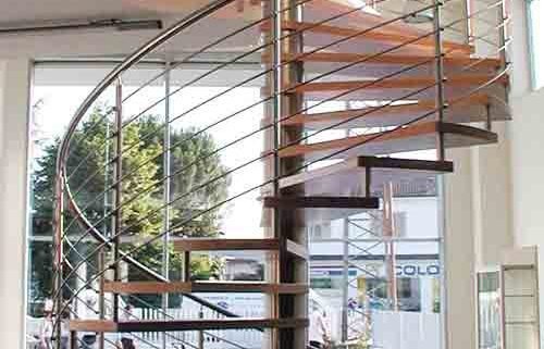 large spiral staircase in a showroom with tiled floor