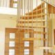 spiral stair with stainless handrail and wooden steps with doorway above and below