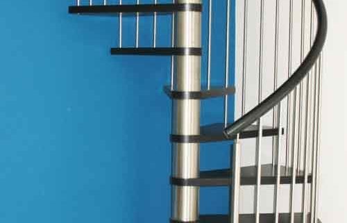 black timber spiral stair with stainless steel balustrade with blue wall behind