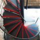 black steel spiral stair with red painted nosing