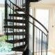 black spiral staircase with dark wood handrail and steps