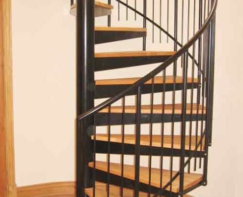 black spiral staircase with steel handrail and spindles with oak treads