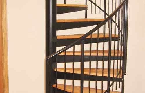 black spiral staircase with steel handrail and spindles with oak treads