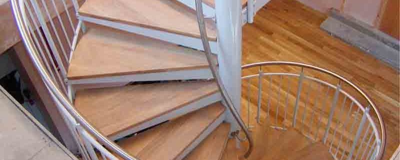 a steel and wooden spiral stair with timber flooring