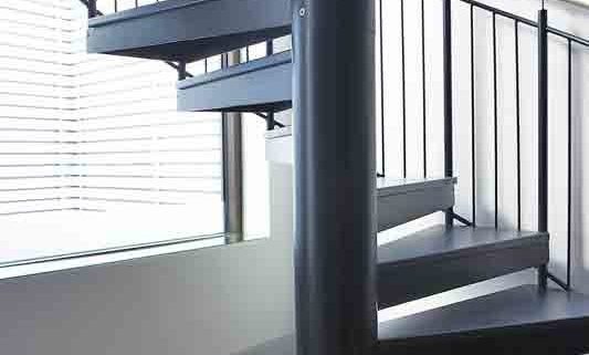 large centre column of a spiral staircase with steel steps