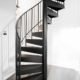 small black spiral staircase with light grey floor below