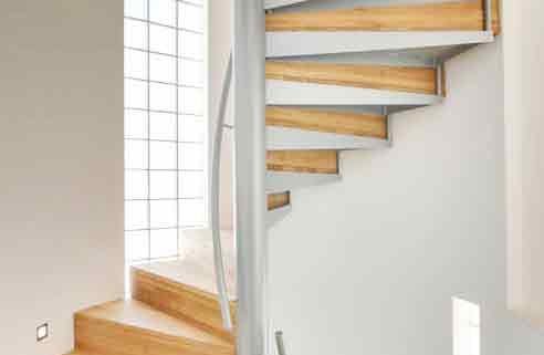 grey and timber spiral staircase with curved white wall behind