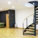black and wood spiral stair on a timber floor in a commercial setting