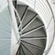 spiral stair with carpeted steps and steel column