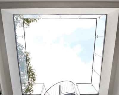 looking up at an external stairwell with glass balsutrade