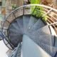 perforated grey steel steps on a spiral stair outside