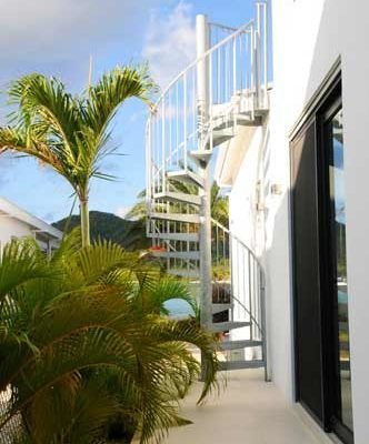 sky and sea to rear of an outdoor spiral staircase