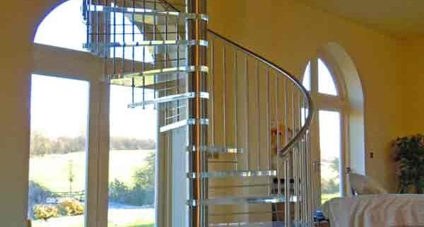large stainless steel spiral stair with acrylic steps