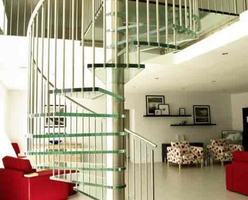 living space with red sofa and a glass spiral stair