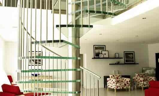 living space with red sofa and a glass spiral stair