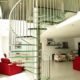 living space with red sofa and a glass spiral stair