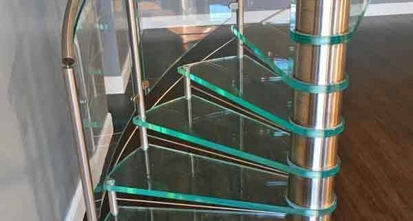 bottom section of a spiral stair with green glass steps