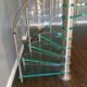 bottom section of a spiral stair with green glass steps