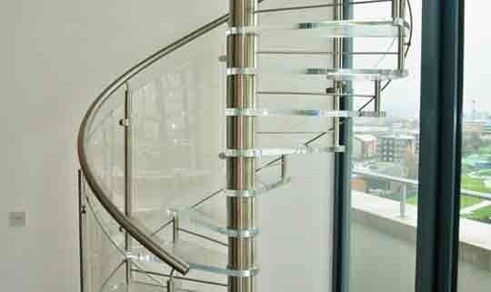 spiral stair with acrylic steps and stainless handrail