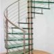glass spiral stair set in curved wall