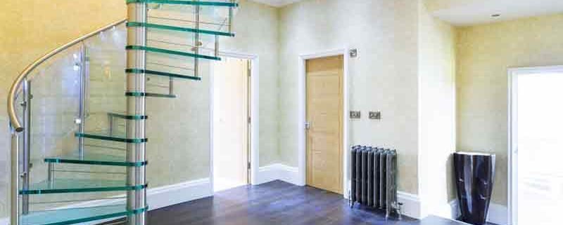 dark floor hallway with a glass step spiral stair rising above