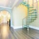 glass spiral staircase in a large hallway