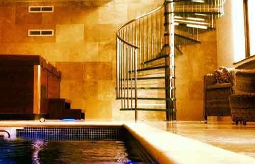 swimming pool with glass step spiral staircase