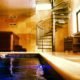 swimming pool with glass step spiral staircase