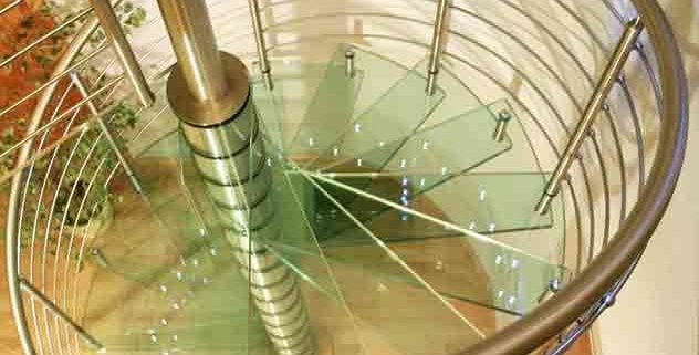 glass steps on a spiral stair with a stainless handrail