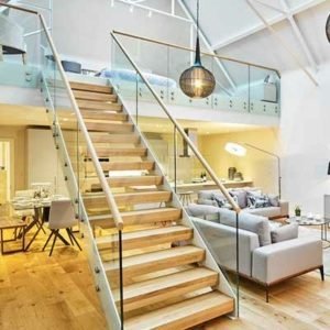 straight flight white steel and glass stair leading to a mezzanine