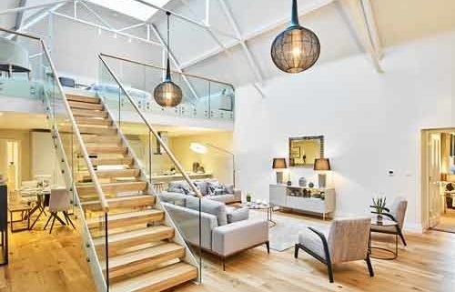 straight flight white , wood and steel stair rising to a mezzanine