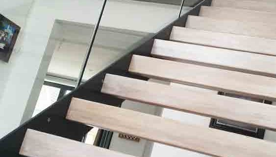 close up of open riser staircase with light wooden steps