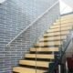modern open riser stair in front of a brick wall