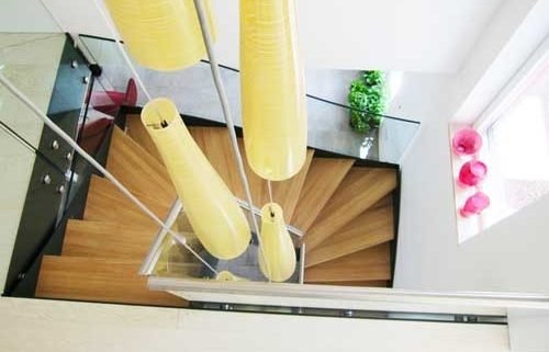 looking down on a half turn oak and glass staircase