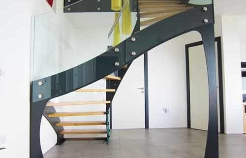 rear of black staircase with frameless glass balustrade