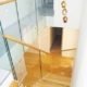 looking down an oak step stair with glass balustrade
