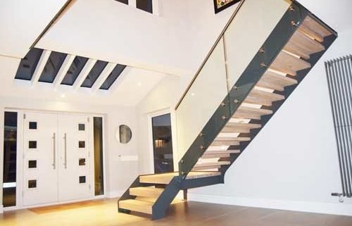 staircase with open risers and platform in large hallway