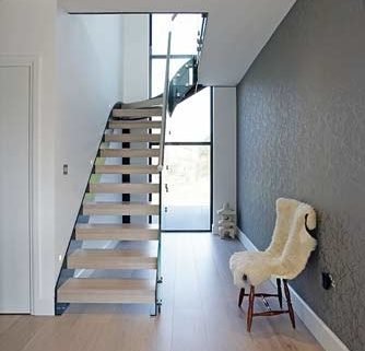light wooden floor with modern stair rising Infront of window