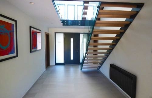 hallway with tiled floor and open riser staircase