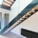 straight dark grey steel staircase with frameless glass