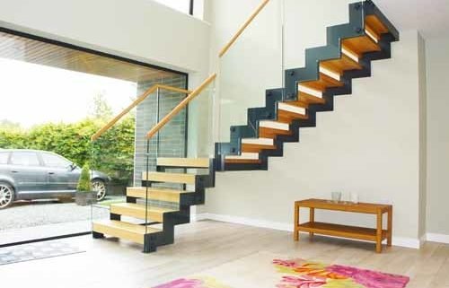 large window in hallway with moderns staircase with zig zag stringers