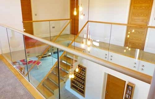 glass landing balustrade around large stair void
