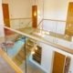 glass landing balustrade around large stair void